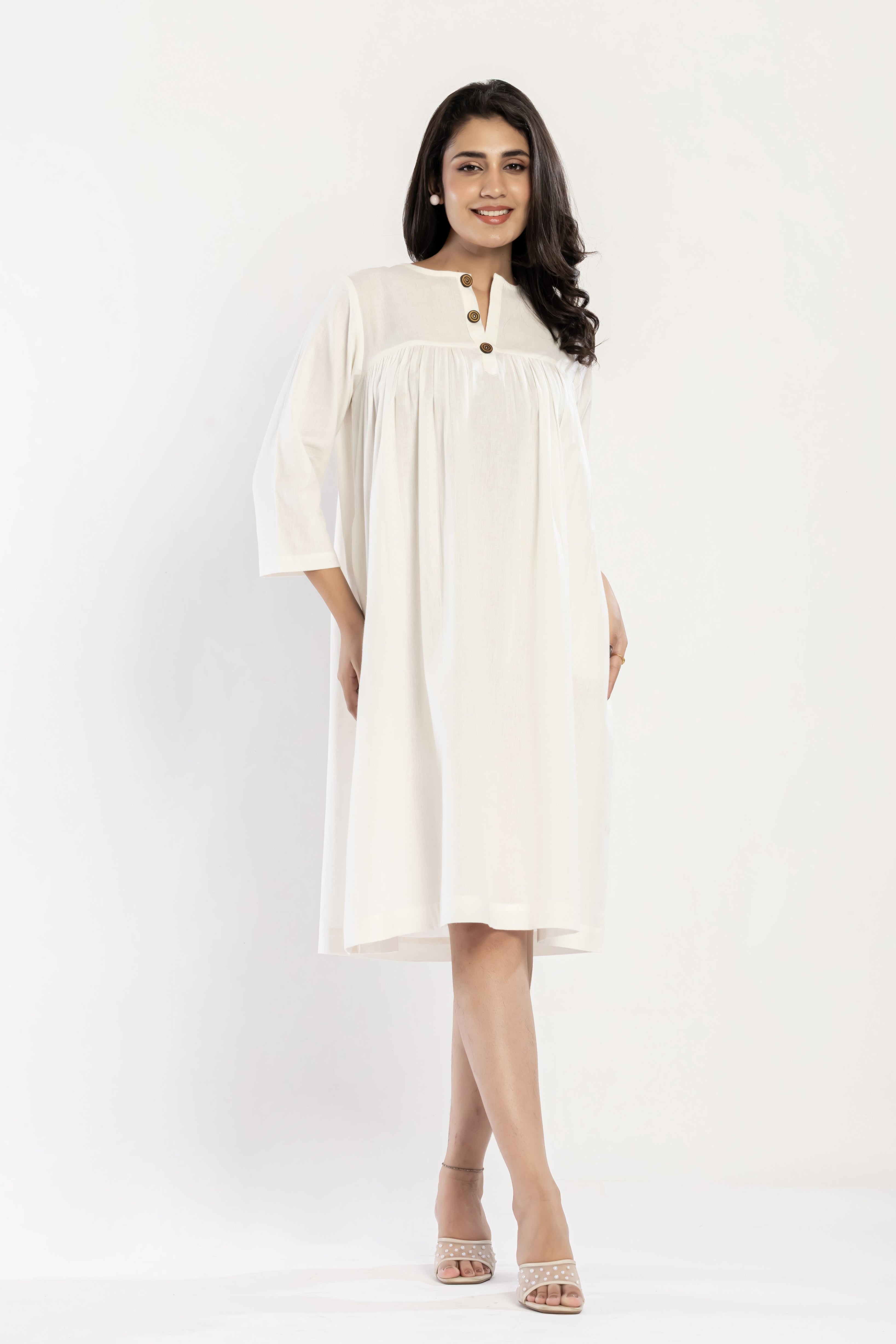 Woman wearing a white dress on a white background