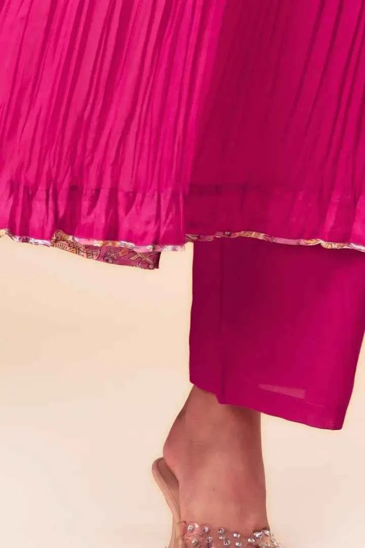 Close-up of a bright pink skirt with a subtle pattern on a beige background